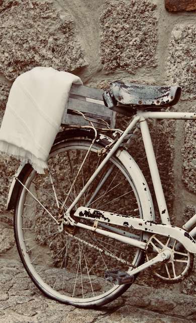 White WAY beach towel on the back of a white bike
