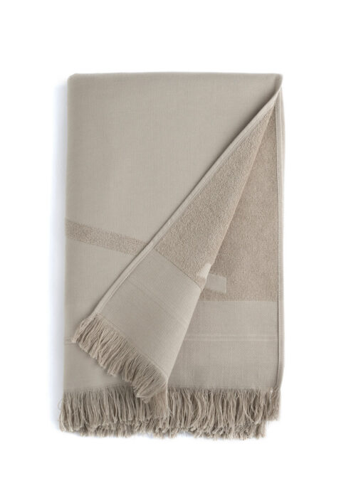 Folded grey WAY beach towel with woven front and terry back and fringes