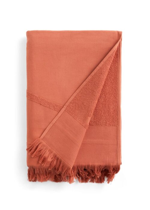 Folded red WAY beach towel with woven front and terry back and fringes