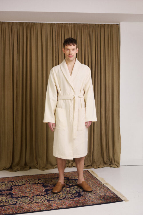 WAY unisex Marin Bathrobe in cream white on male model in front of a curtain in a bungalow mansion