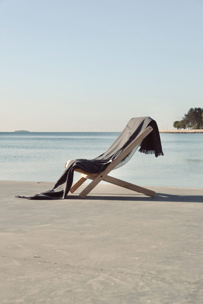 WAY beach towel in dark grey on beach chair by the ocean