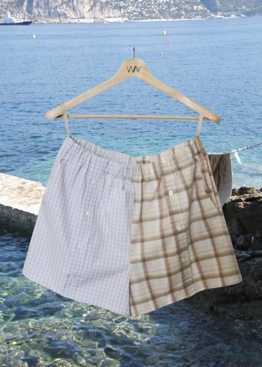 Upcycled blue striped SUN Shorts from WAY collaboration with Salvation Army with ocean back ground