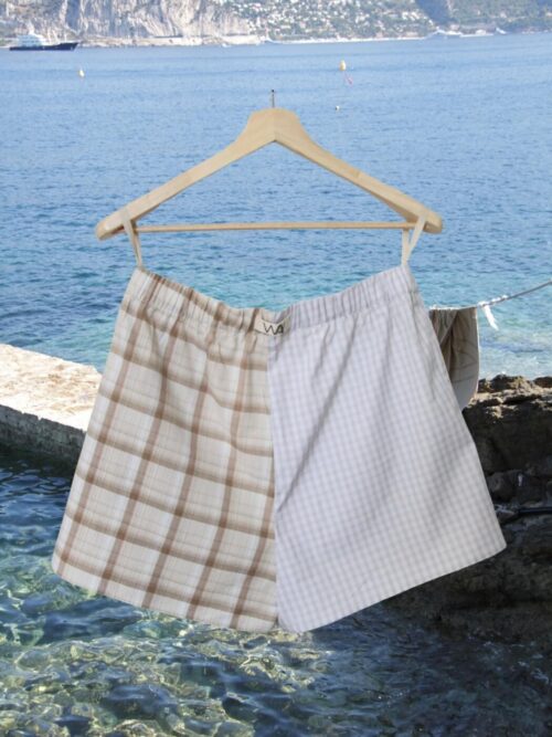 Upcycled blue striped SUN Shorts from WAY collaboration with Salvation Army with ocean back ground