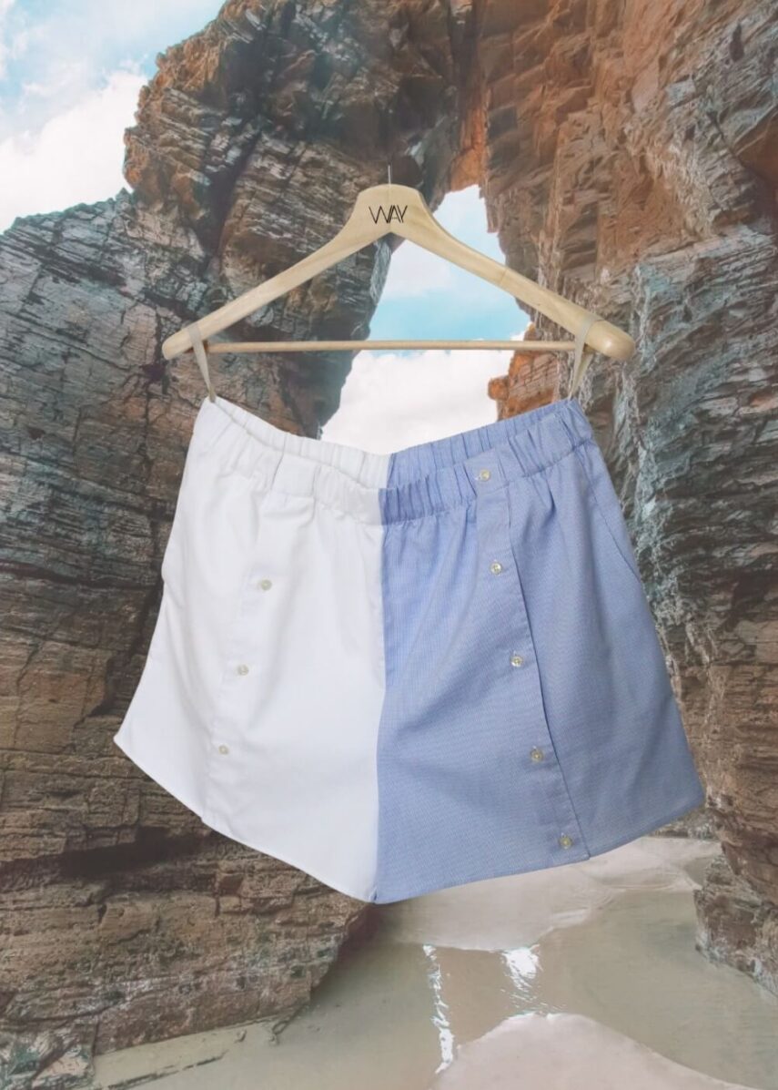 Upcycled blue striped SUN Shorts from WAY collaboration with Salvation Army with ocean back ground
