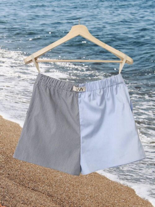 Upcycled blue striped SUN Shorts from WAY collaboration with Salvation Army with ocean back ground