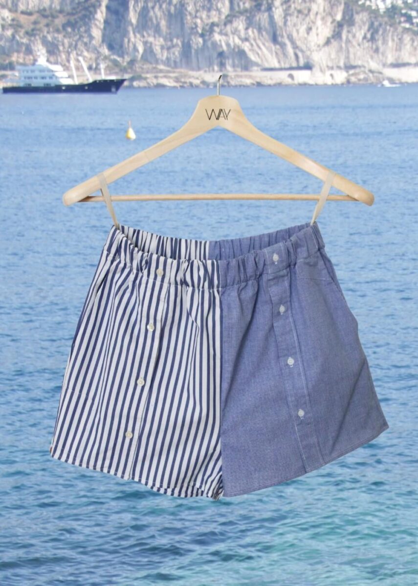 Upcycled blue striped SUN Shorts from WAY collaboration with Salvation Army with ocean back ground