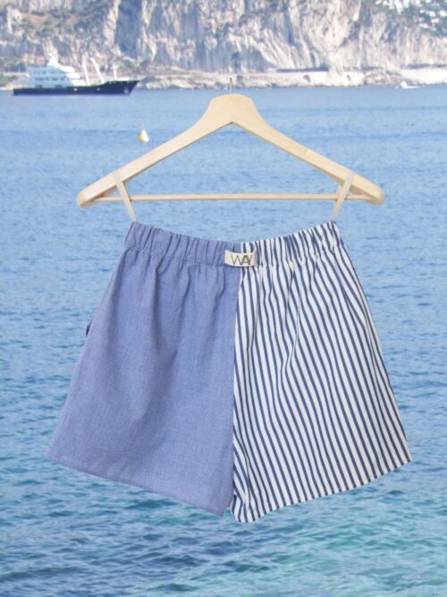 Upcycled blue striped SUN Shorts from WAY collaboration with Salvation Army with ocean back ground