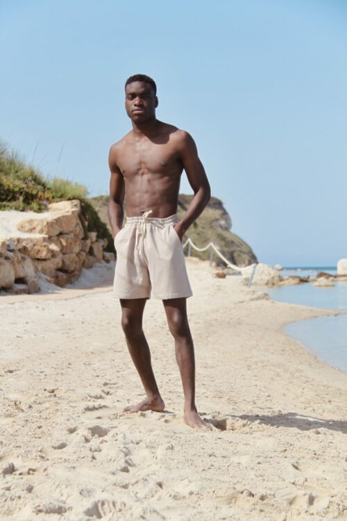Unisex Paloma Beach shorts in Sand grey on the beach