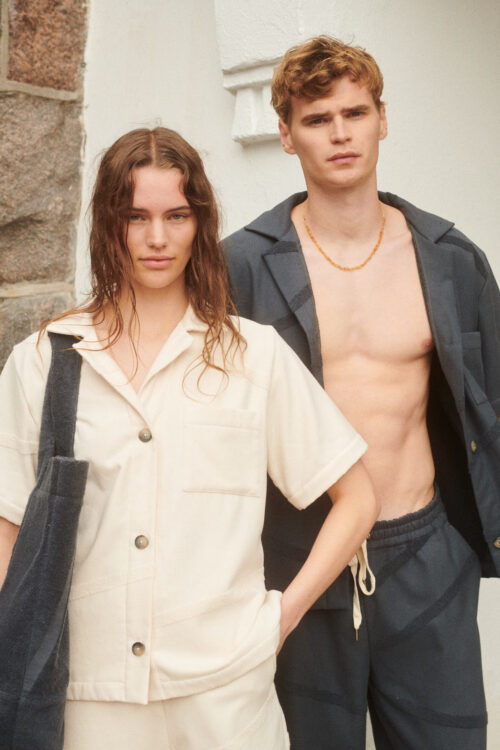 Female and male model wearing WAY Bilbao shirt in white and grey colors for the beach