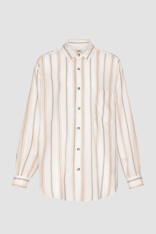 Lifestyle image of boxy beach shirt in cream white with orange and navy stripes.