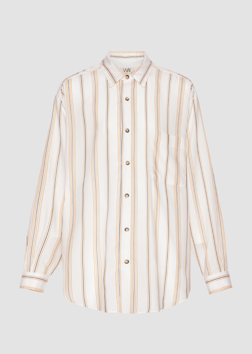 Lifestyle image of boxy beach shirt in cream white with orange and navy stripes.