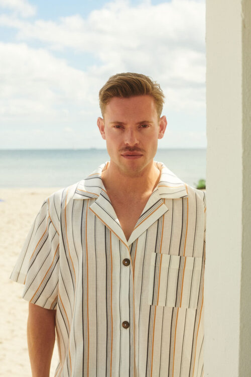 Close-up of man wearing shirt at the beach